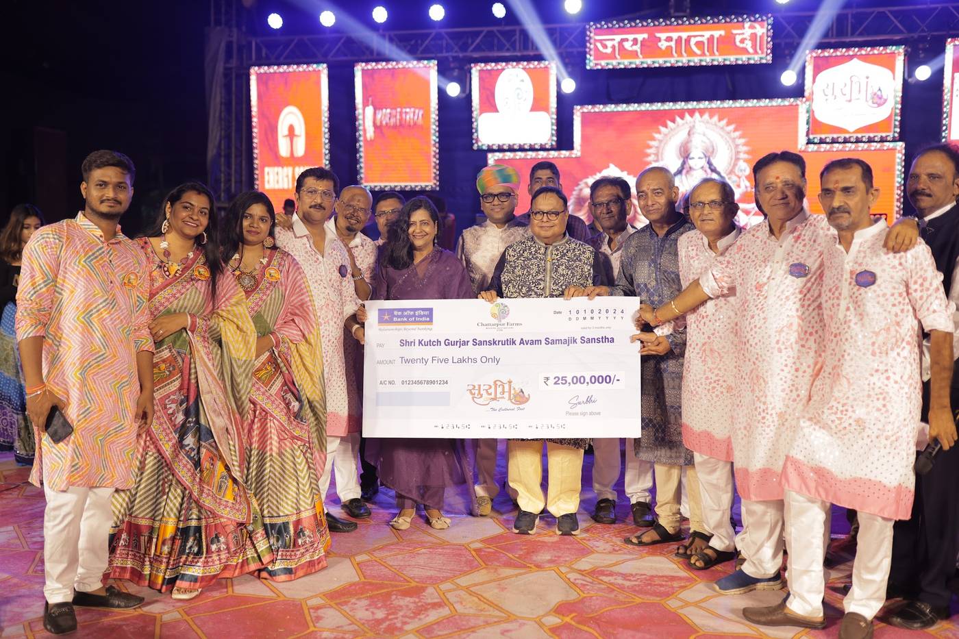 A group on stage at Surbhi Dhoom Dandiya presenting a contribution to Shri Kutch Gurjar Sanskrutik Avam Samajik Sanstha.